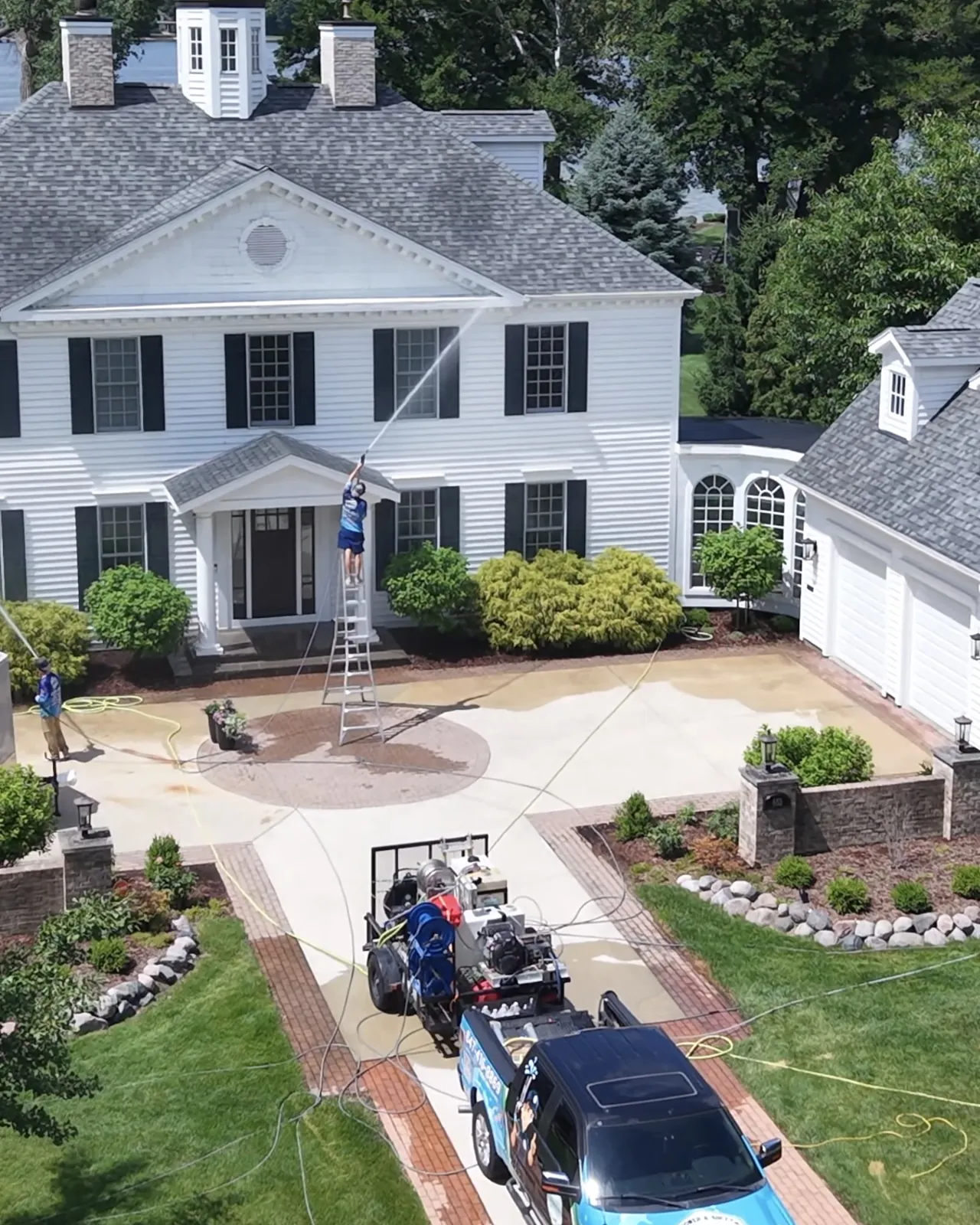 Our truck in the driveway of a stone home, seen from above