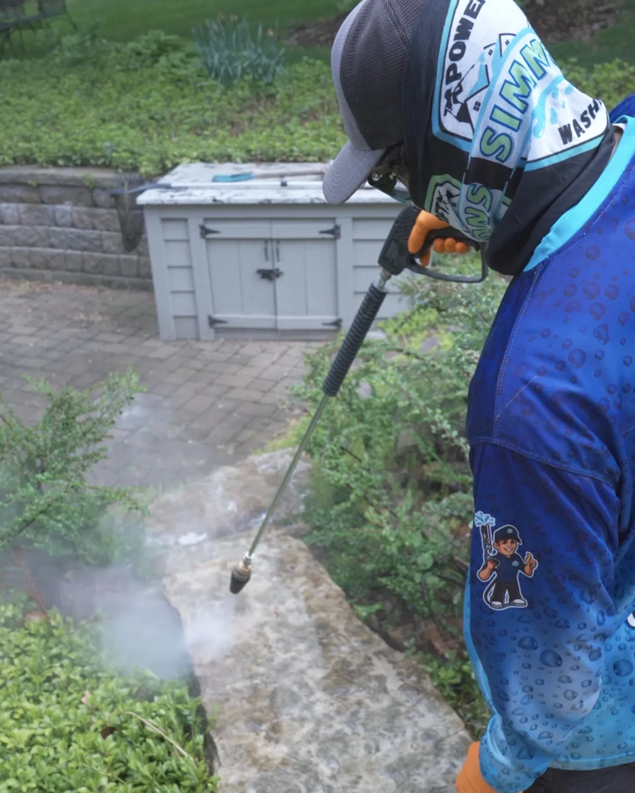 A crew member rinsing a wall