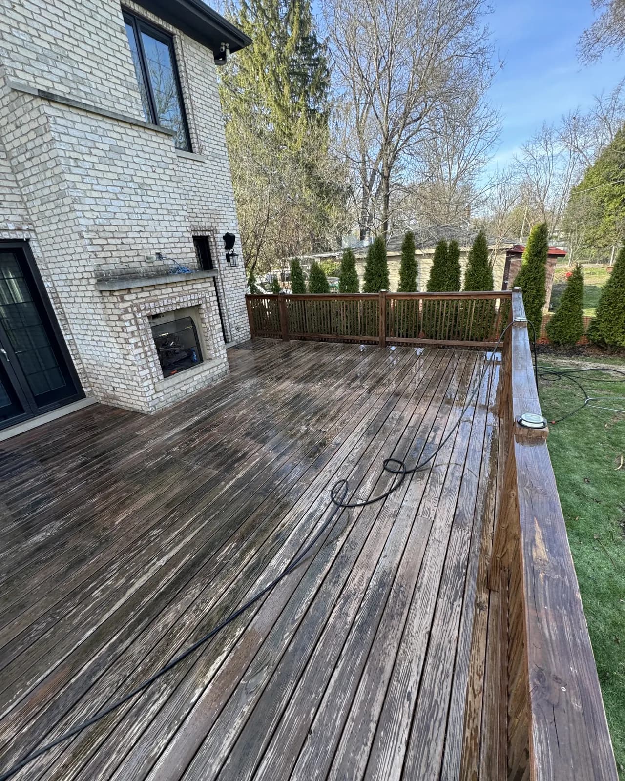 A wood deck half cleaned