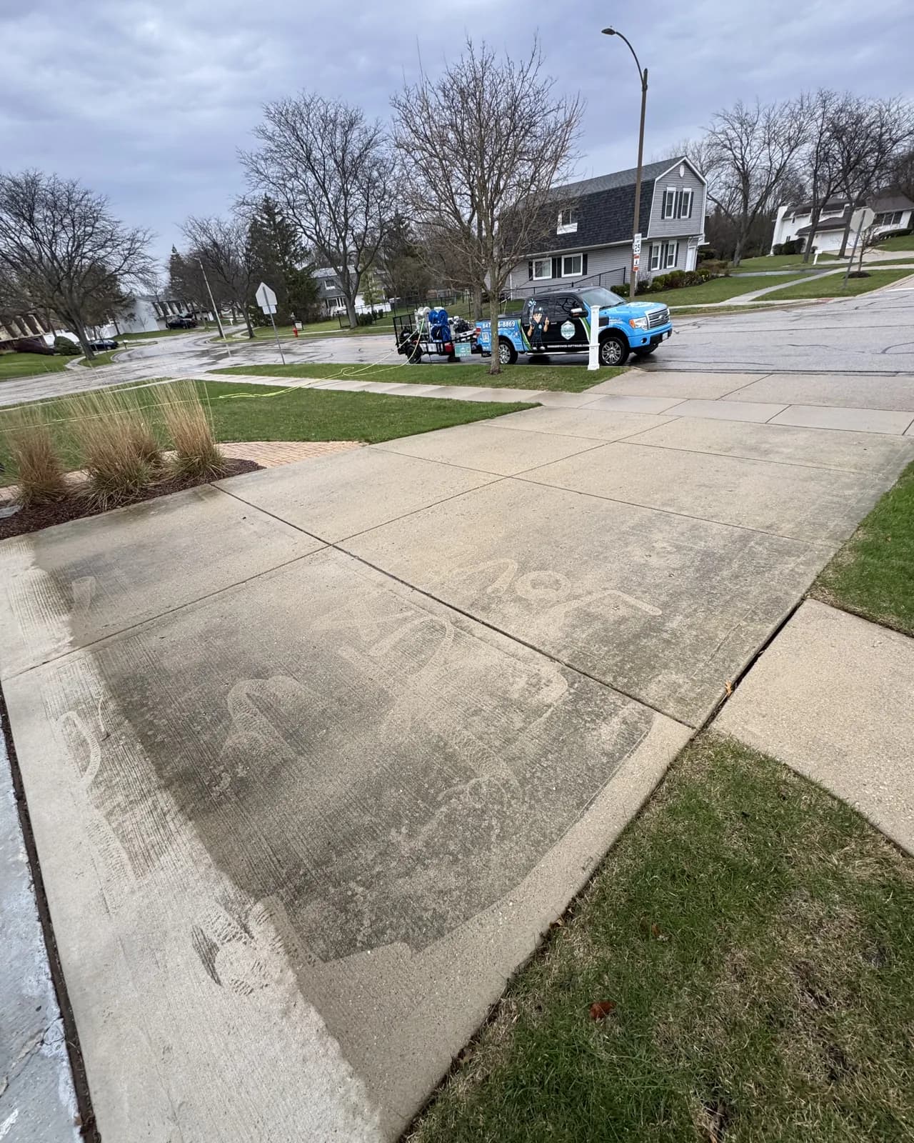 A driveway half cleaned