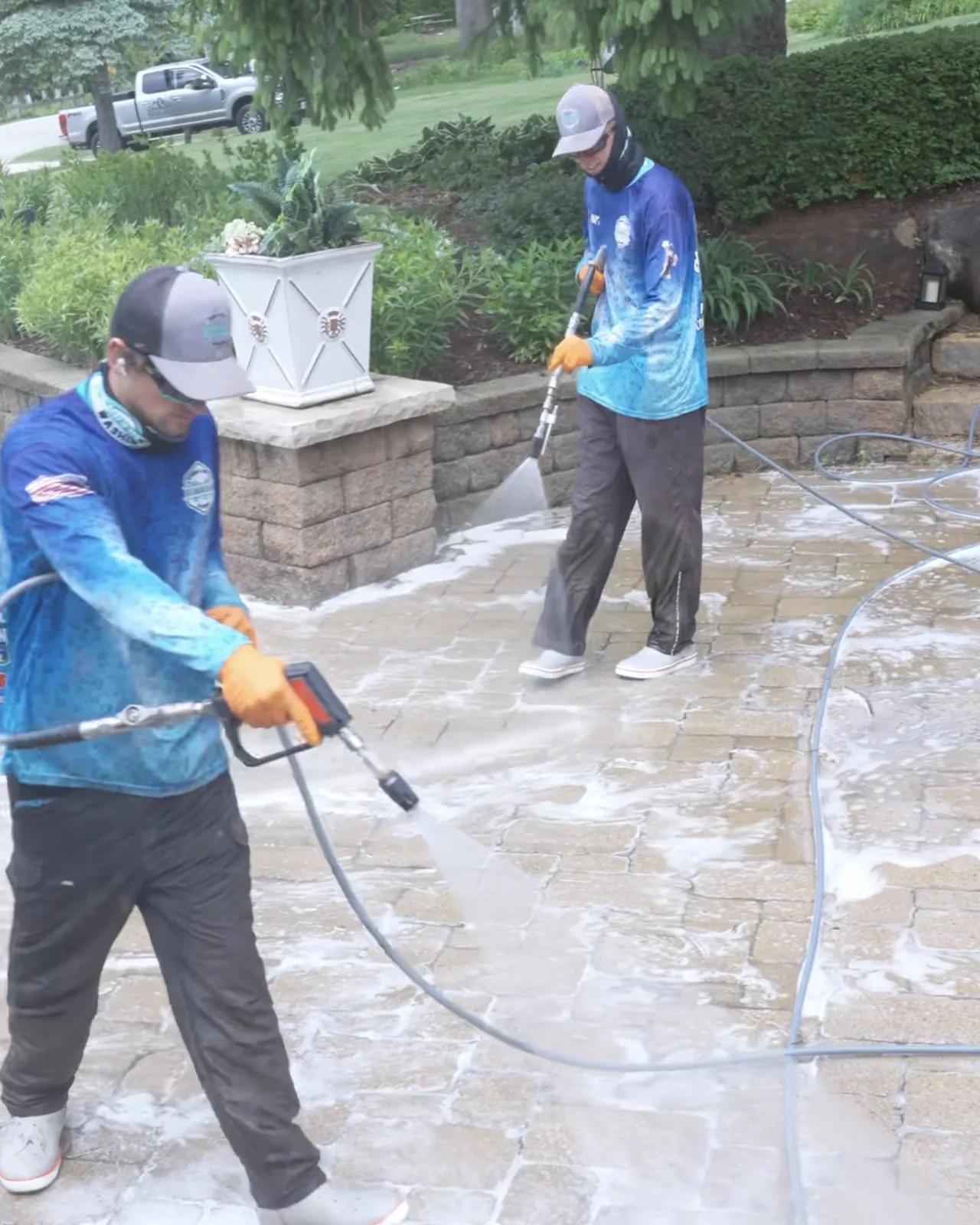Two crew on pavers with wands