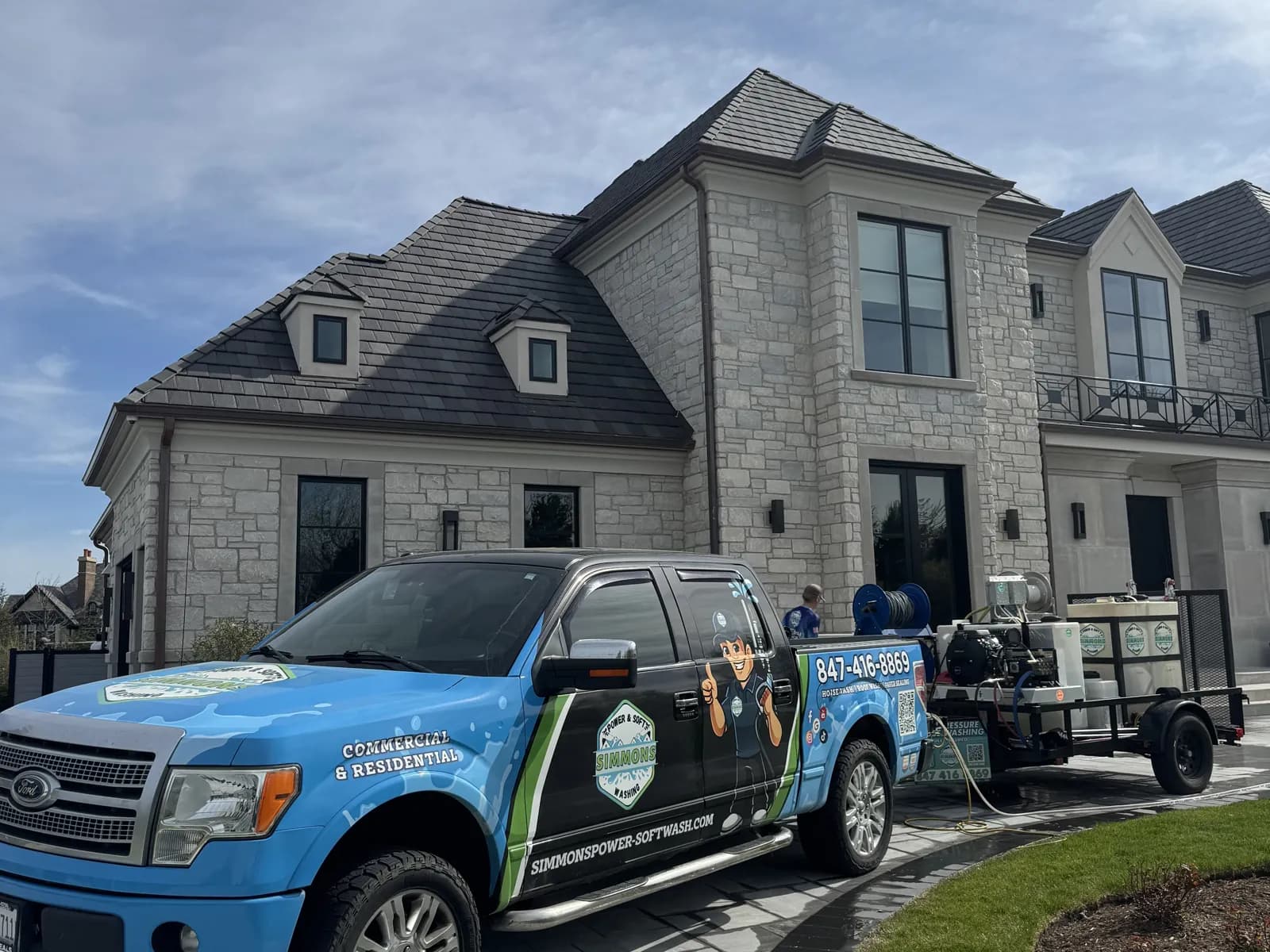 Our truck and trailer in front of a stone home